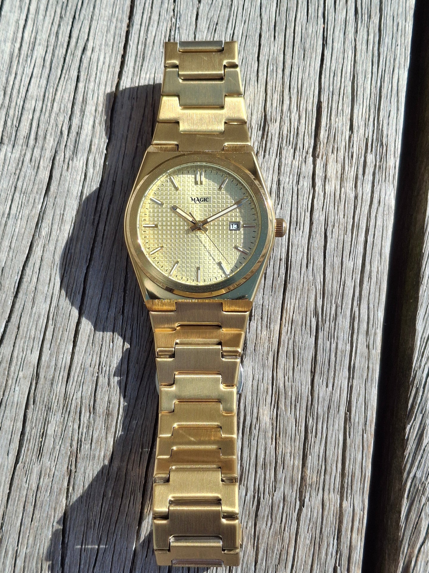 Gold watch on a wooden surface